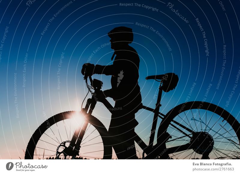 silhouette of a Cyclist Riding Bike at Sunset. Sport Concept. Lifestyle Relaxation Leisure and hobbies Adventure Summer Mountain Sports Cycling Masculine