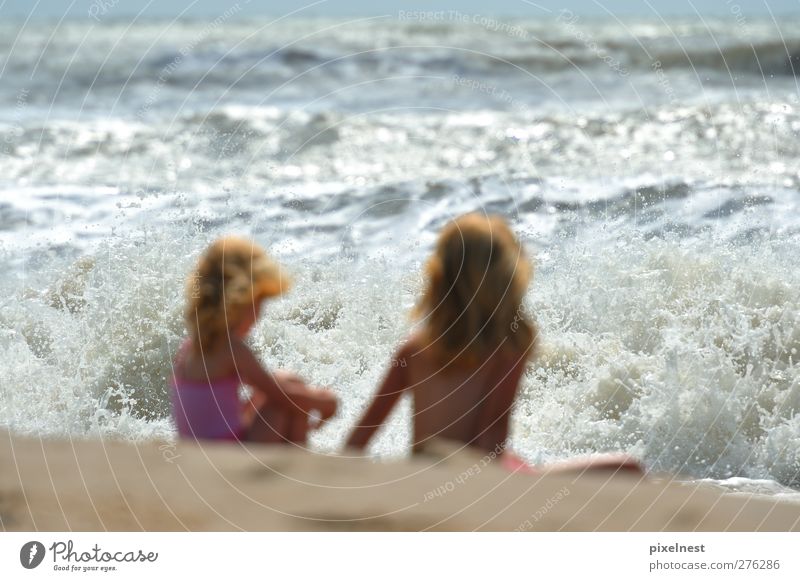 summer happy family of two years blonde baby with blue swimsuit walking in  water ocean holding hand with woman mother bikini in Stock Photo - Alamy