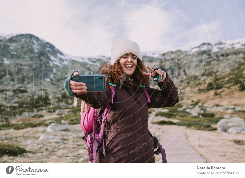 brunette girl with her backpack she takes a picture Lifestyle Happy Vacation & Travel Tourism Trip Adventure Freedom Mountain Telephone Camera Human being Woman