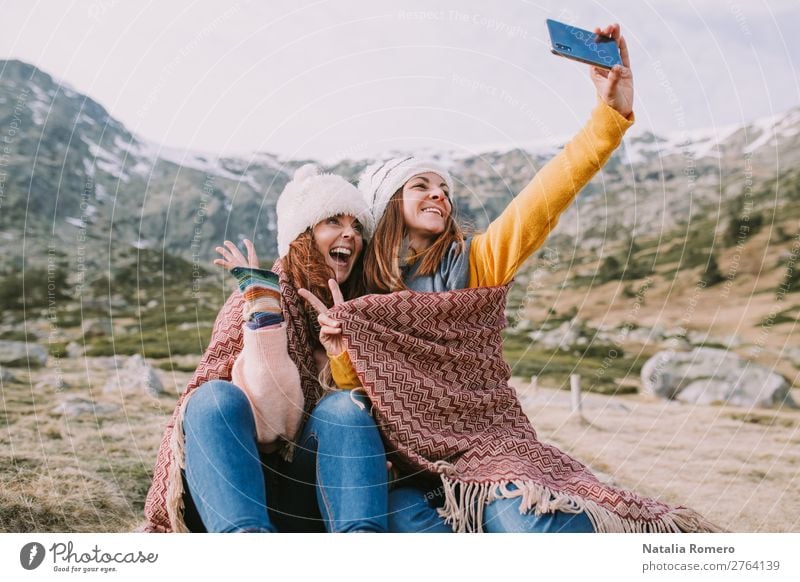 two girls are sitting in the meadow and take a photo Lifestyle Joy Happy Beautiful Vacation & Travel Tourism Adventure Freedom Mountain Hiking Telephone