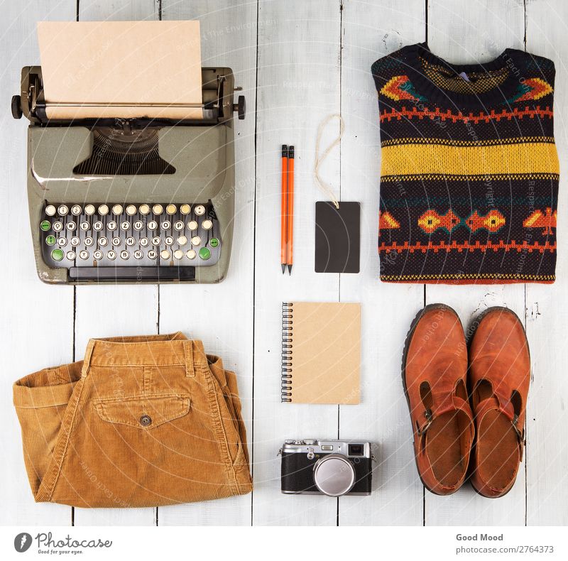 typewriter, notepad, camera, clothes and shoes Reading Vacation & Travel Trip Table Camera Clothing Pants Jeans Sweater Leather Accessory Footwear Boots Pack