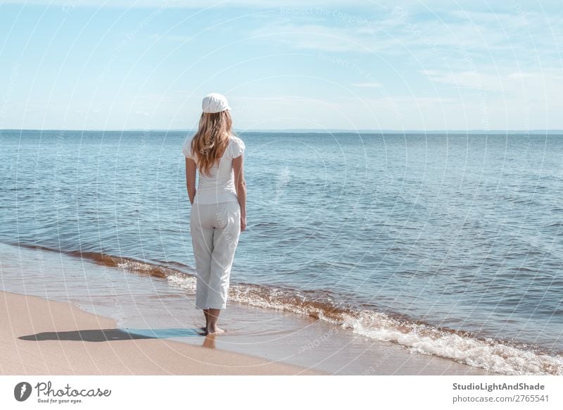 Young woman in white looking at water Lifestyle Beautiful Relaxation Calm Leisure and hobbies Vacation & Travel Tourism Beach Ocean Waves Human being Woman