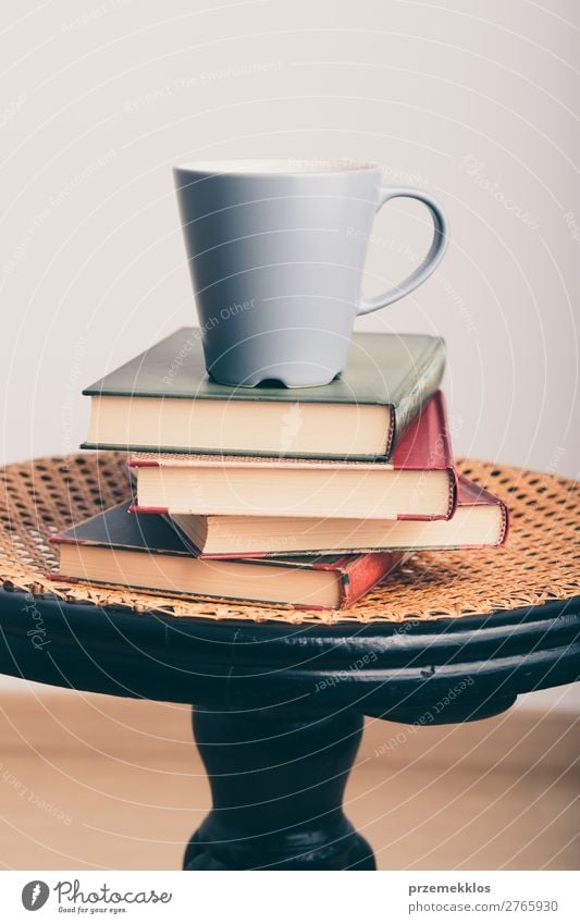 A few books with cup of coffee on chair Coffee Mug Lifestyle Relaxation Leisure and hobbies Reading Chair Table Book To enjoy Brown Safety (feeling of)