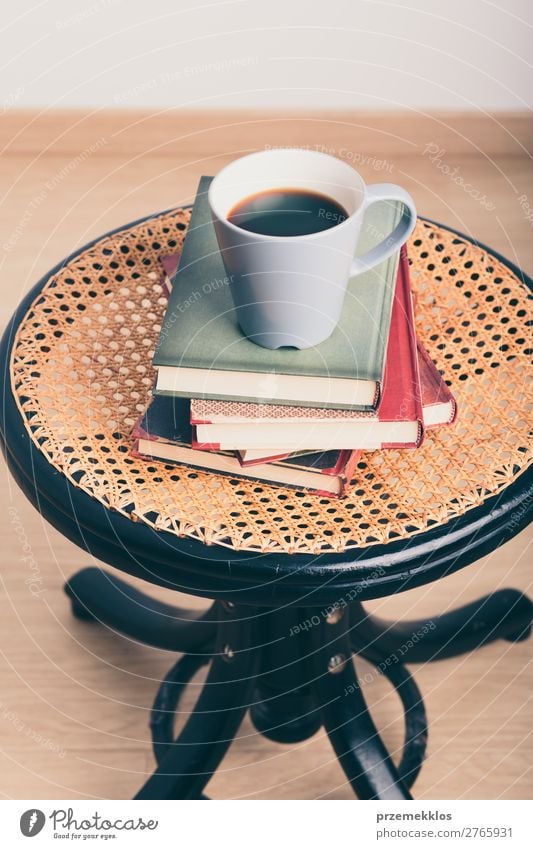 A few books with cup of coffee on chair Coffee Mug Lifestyle Relaxation Leisure and hobbies Reading Chair Table Book To enjoy Safety (feeling of) Comfortable