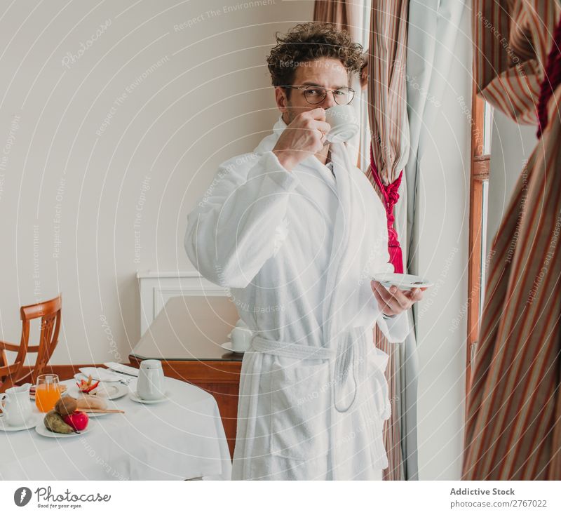 Man in bathrobe with cup Bathrobe Self-confident Style ceramic Cup Window Drinking Breakfast Room service Hotel Bedroom Home Interior design Furniture