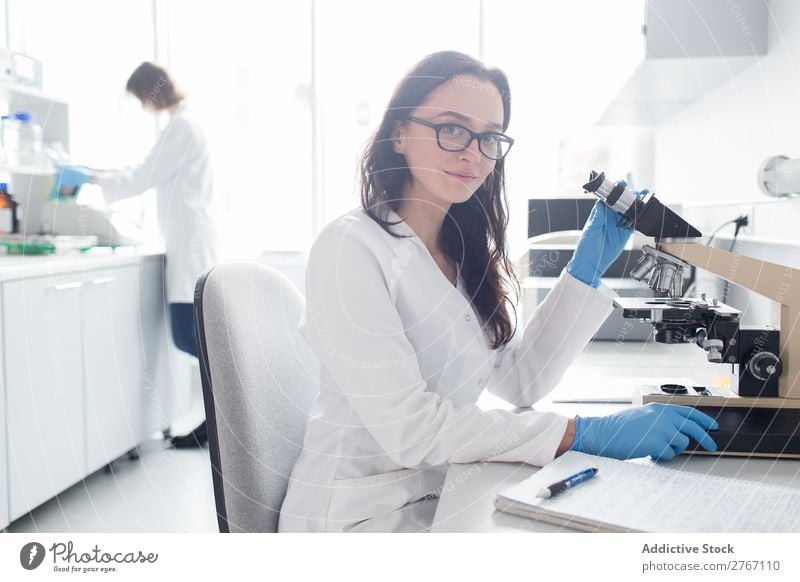 Woman working with microscope Laboratory Work and employment Science & Research Microscope Observe Human being Scientist Medication Chemistry Technology Doctor