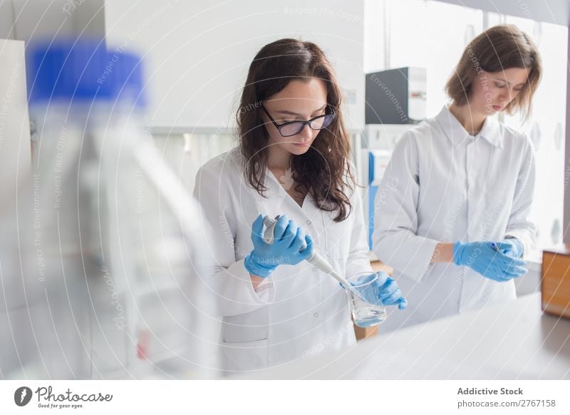 Woman holding flask in lab Laboratory Work and employment Science & Research Erlenmeyer flask Glass Scientist Medication Chemistry Technology Doctor experiment