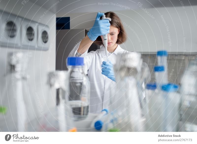 Worker putting liquid to test tube Laboratory Work and employment Science & Research Woman Test tube Liquid pouring Putt Human being Scientist Medication