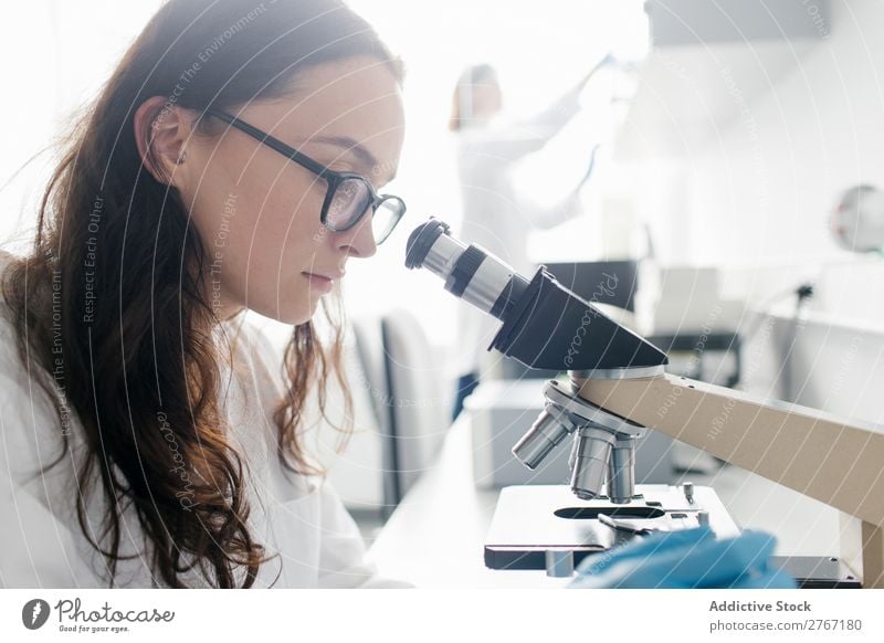 Woman looking at microscope Laboratory Work and employment Science & Research Microscope Observe Human being Scientist Medication Chemistry Technology Doctor