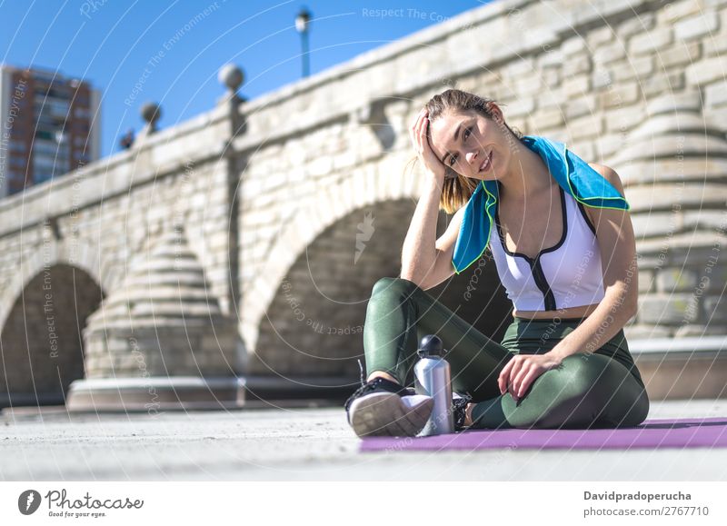 Woman relaxing and drinking water with towel after workout Lifestyle Beautiful Body Relaxation Meditation Sports Yoga Human being Adults Nature Warmth Park