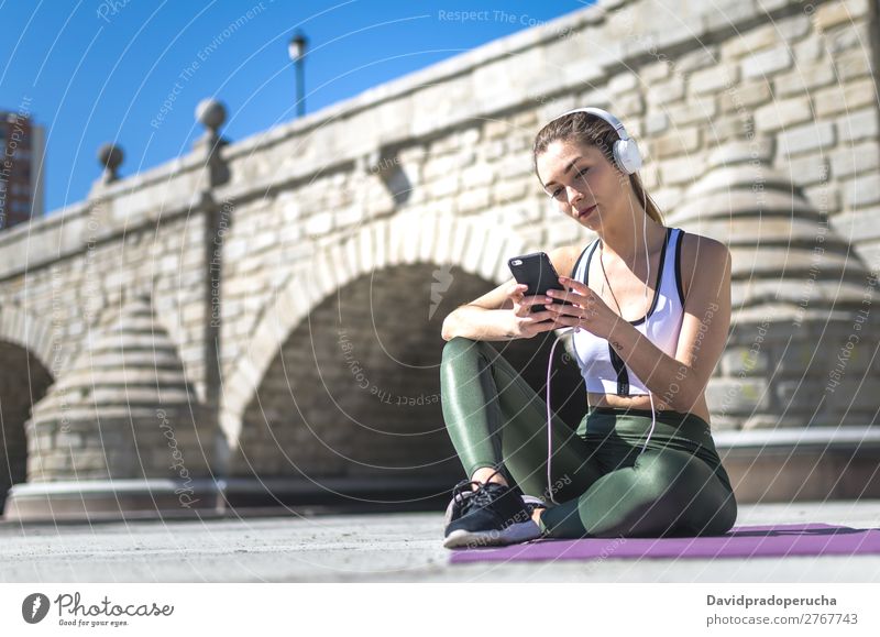 Woman resting and listening music with mobile while working out Lifestyle Beautiful Wellness Relaxation Meditation Music Sports Yoga Human being Adults Nature