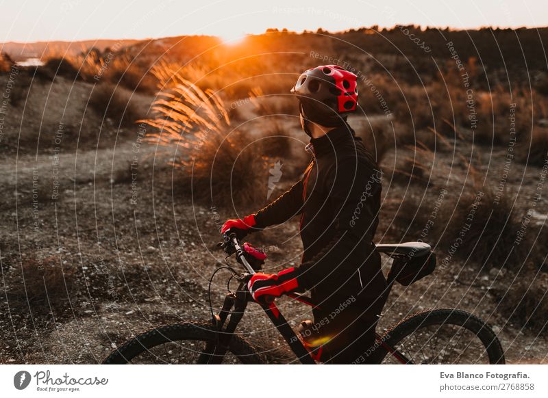 Cyclist Riding the Bike at Sunset. Sports Concept Lifestyle Relaxation Leisure and hobbies Adventure Summer Mountain Cycling Bicycle Masculine Young man