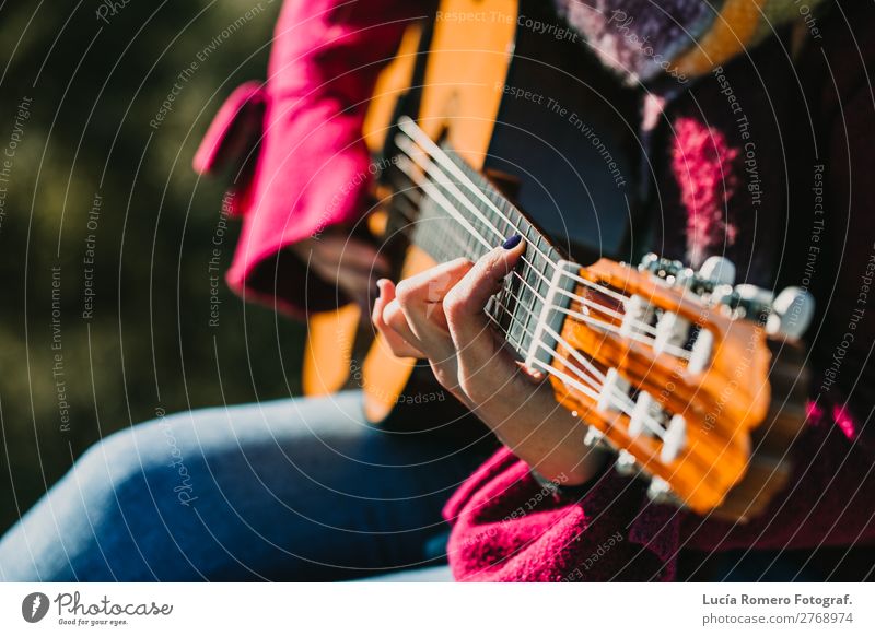 Woman playing guitar outdoors. Lifestyle. Joy Happy Relaxation Leisure and hobbies Vacation & Travel Winter Music Human being Feminine Adults Fingers Concert