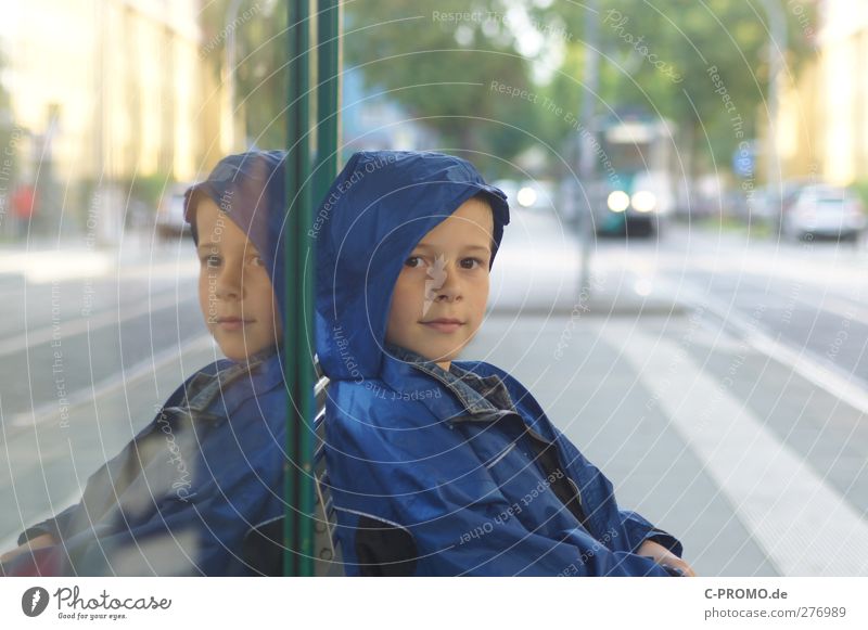 Boy with raincoat sitting at bus stop Human being Masculine Child Boy (child) 1 3 - 8 years Infancy Potsdam Town Train travel Jacket Rain jacket