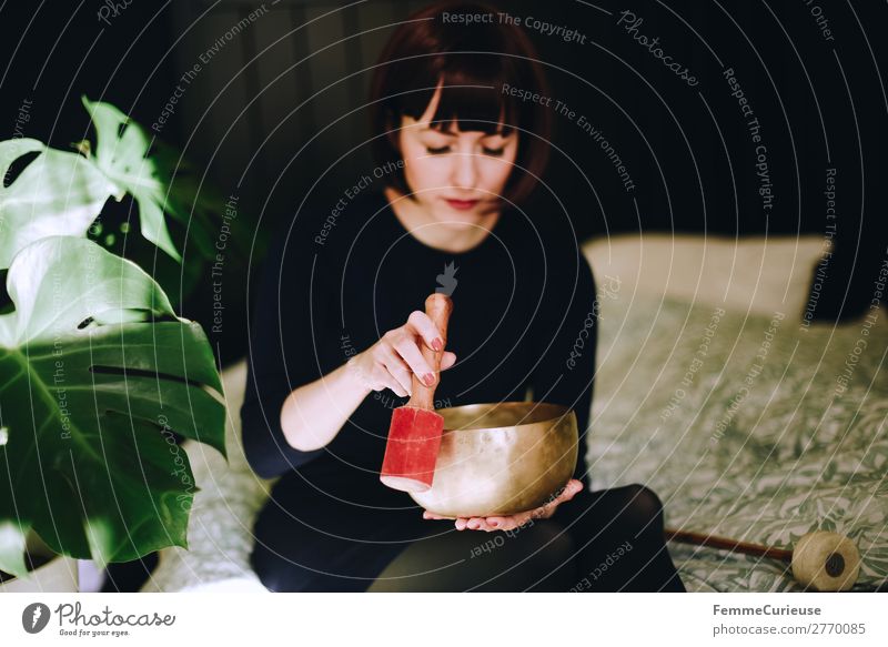 Mindfulness - Woman with singing bowl in her cozy home Healthy Harmonious Well-being Contentment Senses Relaxation Calm Meditation Feminine Adults 1 Human being