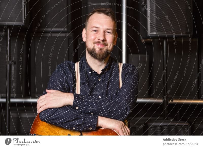 Guitarist sitting on guitar combo Man Shopping Looking into the camera seller Customer rows Musical Acoustic Equipment Human being Business Portrait photograph