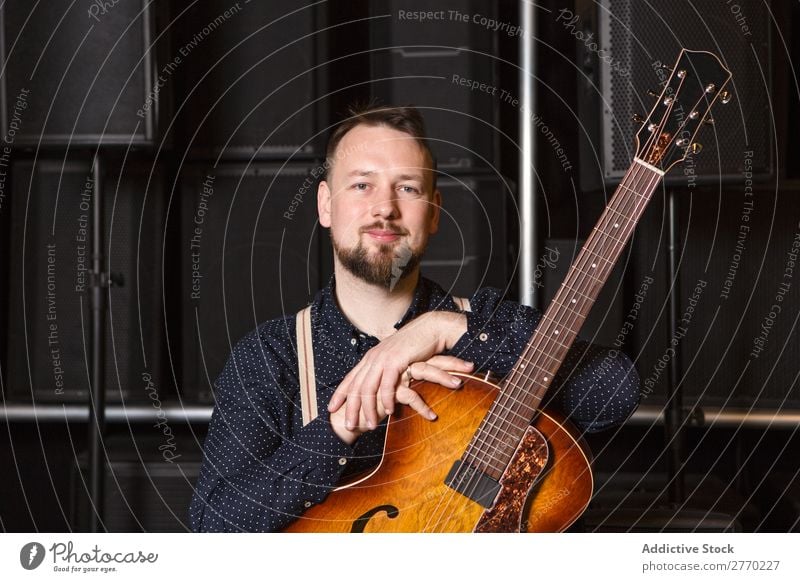 Guitarist sitting on guitar combo Man Shopping Looking into the camera seller Customer rows Musical Acoustic Equipment Human being Business Portrait photograph