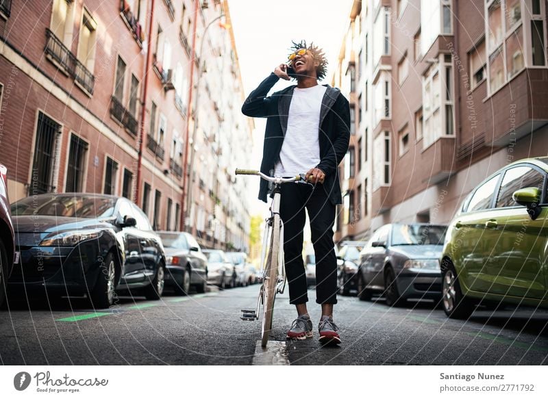 Handsome young man using mobile phone and fixed gear bicycle. Man Youth (Young adults) African Black mulatto Afro Mobile Bicycle fixie Telephone Lifestyle Stand
