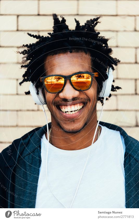 Portrait of afro handsome man listening music. Man Youth (Young adults) African Black mulatto Afro Headphones Mobile Music Listening Telephone Lifestyle Stand