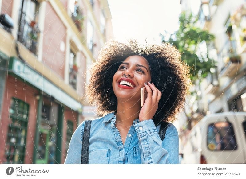 Beautiful afro american woman using her mobile in the street. Woman Black African Afro Human being Portrait photograph PDA Youth (Young adults) Mobile Telephone