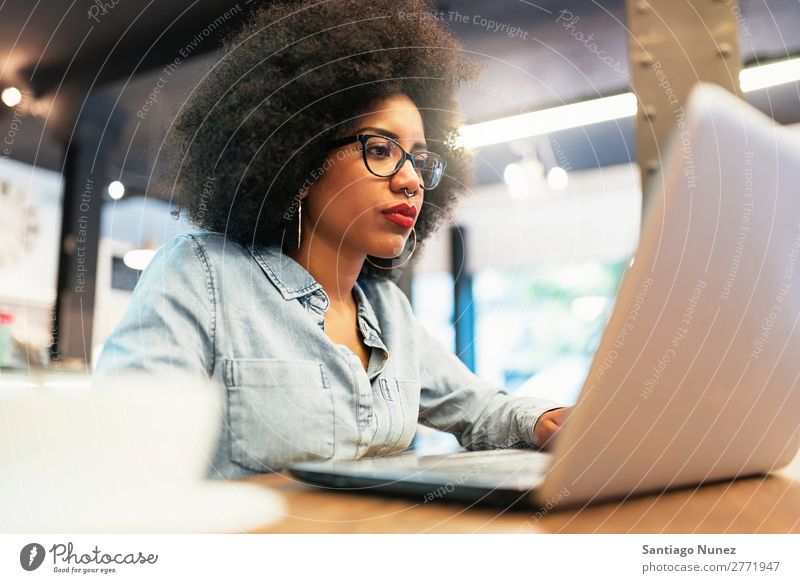 Beautiful afro american woman using mobile and laptop in the coffee shop. Woman Black African Afro Business Coffee Businesswoman Cellphone Youth (Young adults)