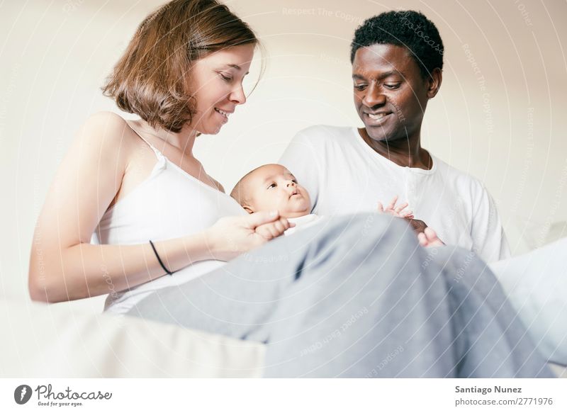 Happy Family, Mother, Father And Baby. Boy (child) Child Bed Girl Lie (Untruth) Newborn Parents multiethnic African diverse Human being interracial Caucasian