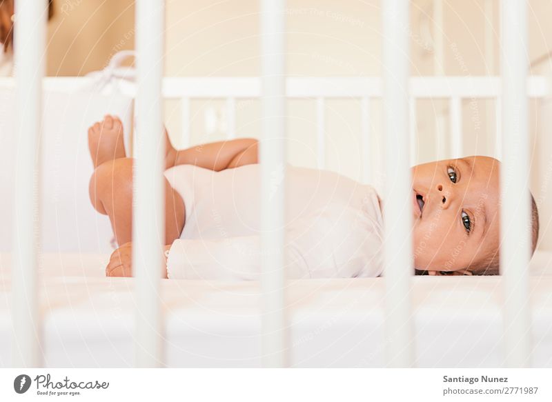 Cute Baby Girl Lying In The Crib A Royalty Free Stock Photo From