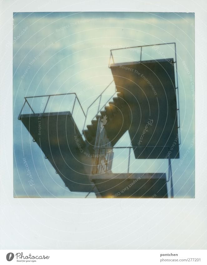 Polaroid shows diving platform in front of blue sky Moody Springboard Platform Stairs Sky Blue high Open-air swimming pool Banister Colour photo Subdued colour