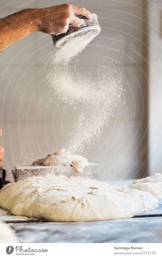 Baker man hand spreading flour to dough. Bread Bakery Dough Flour Food Cooking Make Hand kneading Spread Table Profession Baked goods Factory Fresh Baking