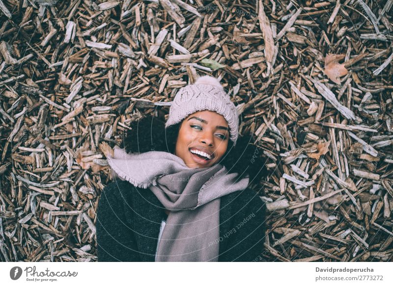Young black beautiful woman lying on peaces of wood near the royal palace in Madrid during winter Woman Vacation & Travel City Town center Wood Cork To talk