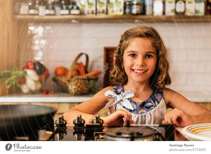 Portrait of little girl preparing baking cookies. Girl Child Nutrition To feed savoring Eating enjoying Portrait photograph Appetite Smiling Laughter Lunch Baby
