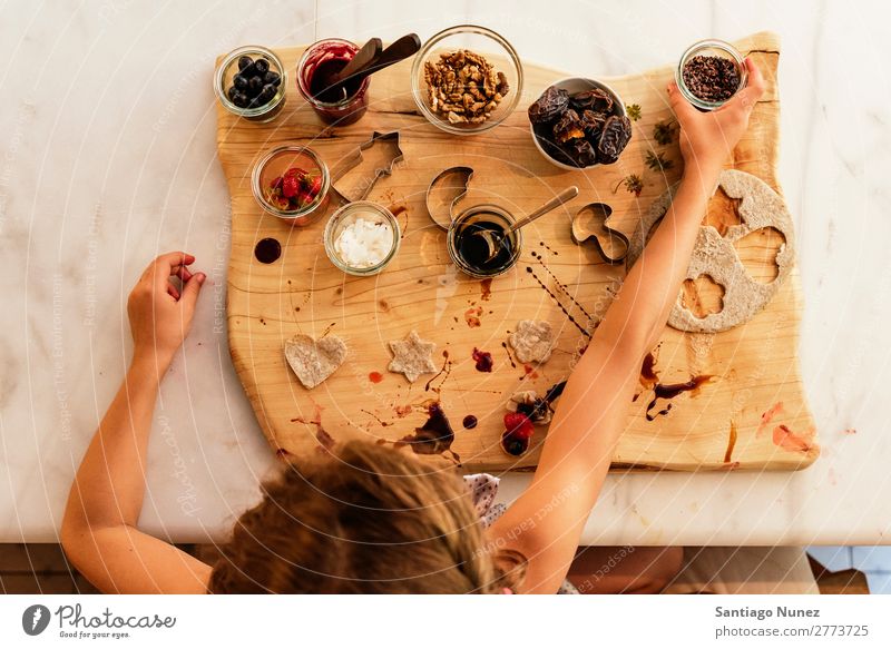 Top view of little girl preparing baking cookies. Girl Child Nutrition Portrait photograph Cooking Kitchen Appetite Preparation Make Lunch Baby Dirty stained