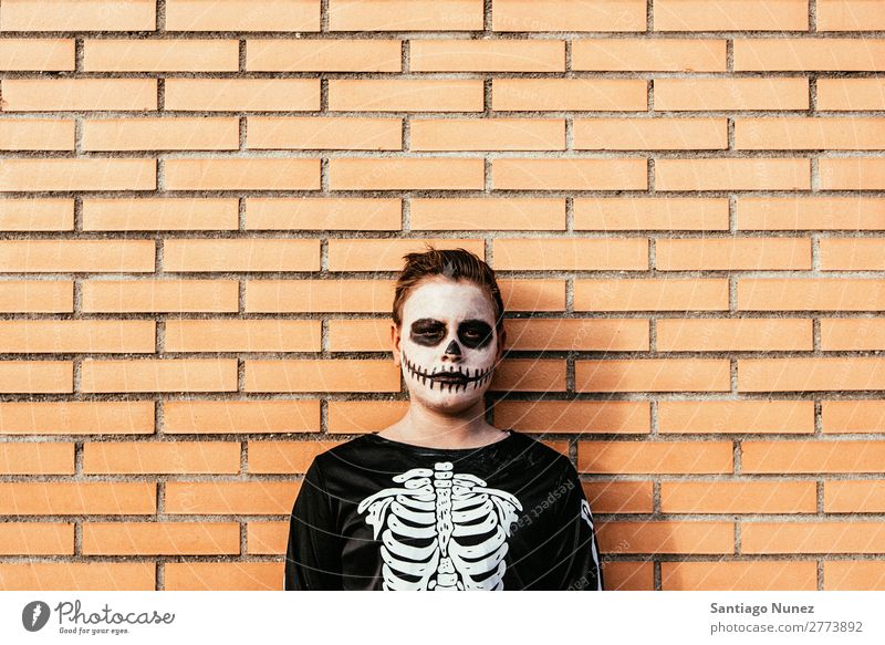 Portrait of boy disguised of skeleton in the street. Hallowe'en Child Boy (child) Painting (action, artwork) Skeleton Joy Family & Relations Brother
