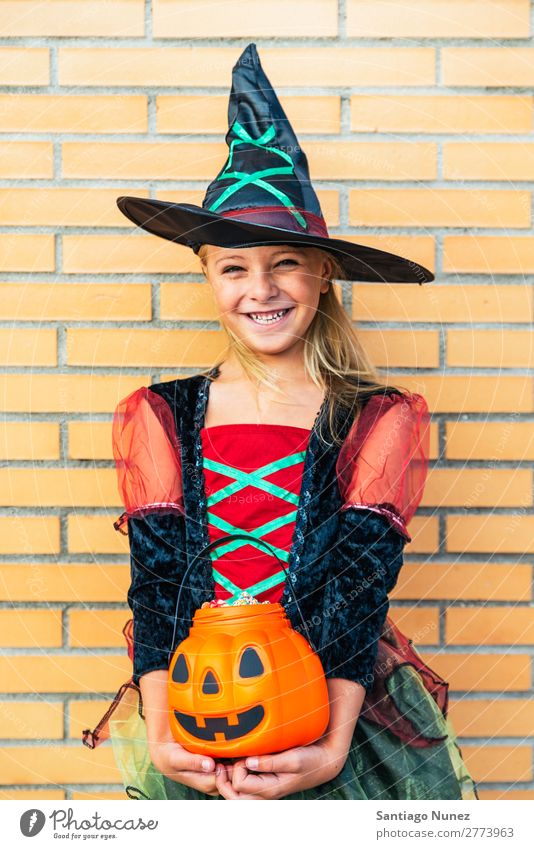 Portrait of beautiful girl disguised of witch in the street. Hallowe'en Child Girl Painting (action, artwork) Disguised Witch Joy Family & Relations Sister