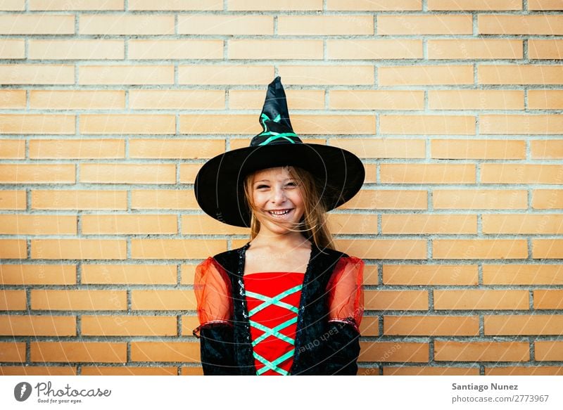 Portrait of beautiful girl disguised of witch in the street. Hallowe'en Child Girl Painting (action, artwork) Disguised Witch Joy Family & Relations Sister