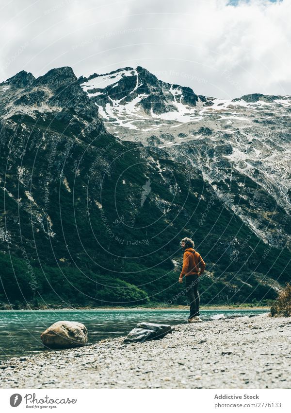 Traveler on lake in mountains Human being traveler Mountain Lake Remote Dream Rock tranquil Nature Vacation & Travel Picturesque Tourism Idyll Landscape Sunset