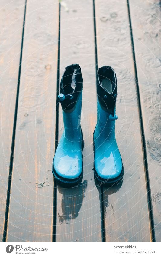 Rain boots standing on a wooden porch while raining Joy Summer Child Human being Woman Adults Man Weather Coat Footwear Boots Rubber boots Small Wet Cute Green