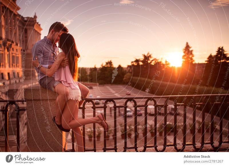 Couple at sunset Embrace Sunset romantic Romance Bridge Vantage point Sky Evening Horizontal Fence Street tender Love Face to face Profile Sunlight