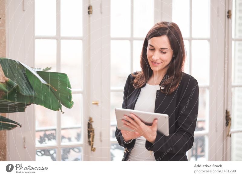 Young smiling woman standing with tablet Woman Tablet computer Smiling Technology Posture Cheerful Stand Gadget Modern Digital Businesswoman Entrepreneur