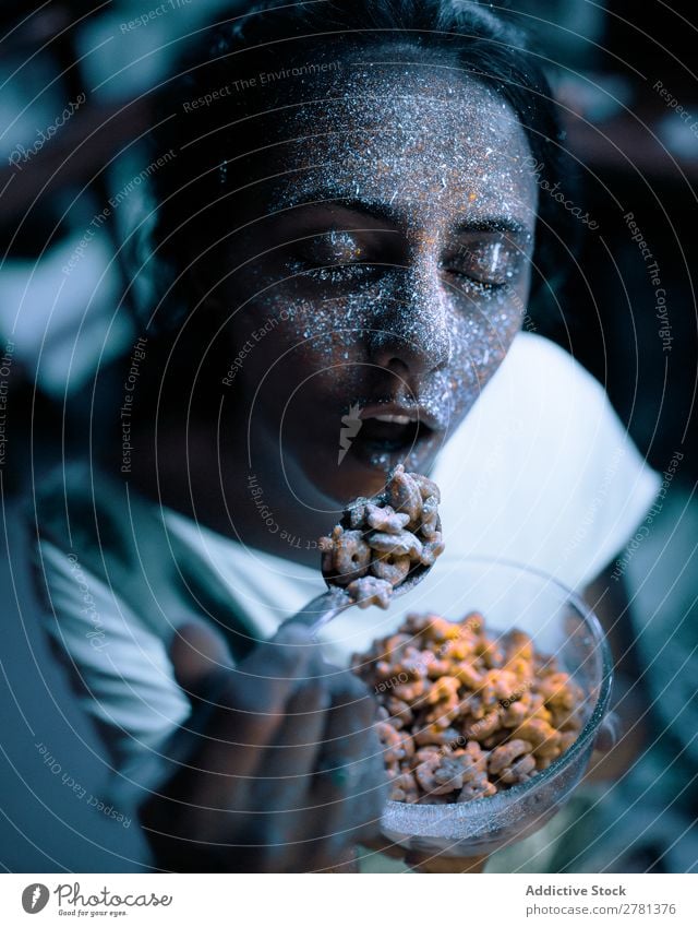 Woman with glitters on face eating cereal Youth (Young adults) pretty Colour Painting (action, artwork) Eating Cereal Food Breakfast Gray Fluorescent Illuminate