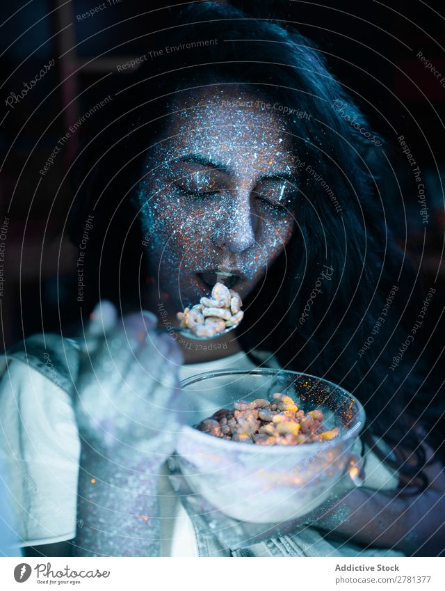 Woman with glitters on face eating cereal Youth (Young adults) pretty Colour Painting (action, artwork) Eating Cereal Food Breakfast Gray Fluorescent Illuminate