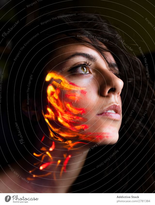 Woman with luminous paint on face Youth (Young adults) pretty Colour Painting (action, artwork) Orange Fire Passion Looking away Fluorescent Illuminate Art Neon