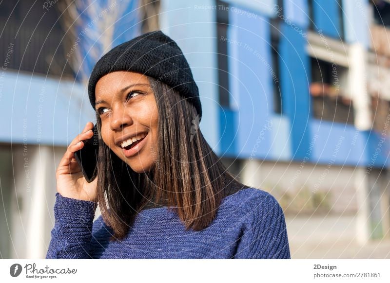 Portrait of a cheerful young african woman standing outdoors Style Joy Beautiful To talk Telephone PDA Technology Human being Feminine Young woman
