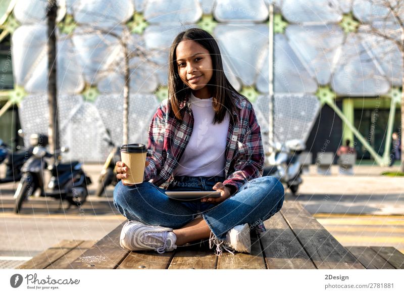 Young beautiful african american woman sitting outdoors Coffee Tea Style Happy Beautiful Computer Technology Internet Human being Feminine Young woman