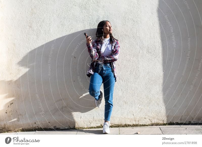 Front view of a young smiling african american woman standing Lifestyle Happy Beautiful Entertainment Music Telephone Human being Feminine Young woman