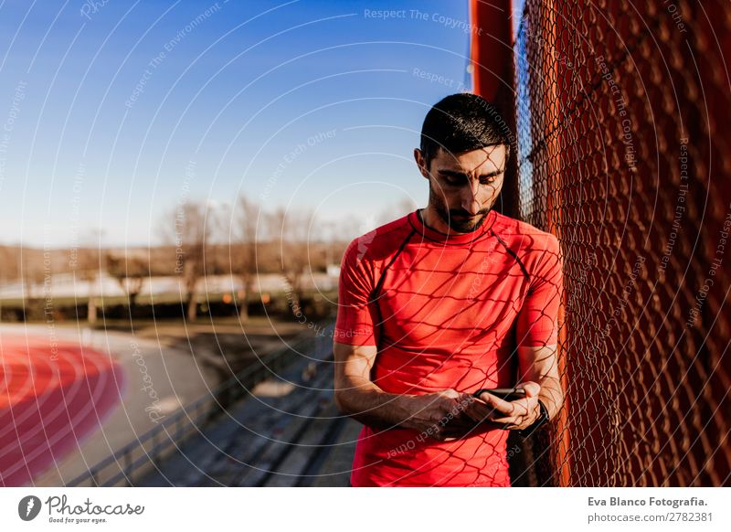 young runner man using mobile phone Lifestyle Leisure and hobbies Sports Sportsperson Stadium Cellphone Technology Human being Masculine Young man