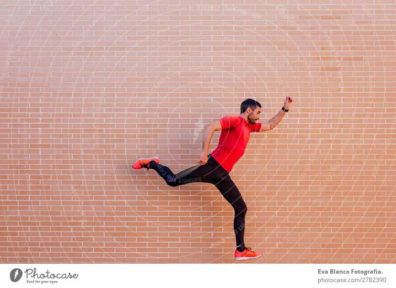 young athlete man jumping over brick background Lifestyle Leisure and hobbies Sports Track and Field Jogging Stadium Human being Masculine Man Adults
