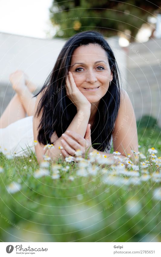 Brunette woman on a flowered meadow Lifestyle Joy Happy Beautiful Face Wellness Relaxation Vacation & Travel Summer Sun Garden Human being Woman Adults Nature