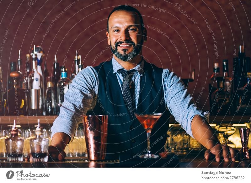 Barman is making cocktail at night club.Barman is making cocktail at night club. Cocktail shaker barman bartender Waiter Man Portrait photograph portraiture