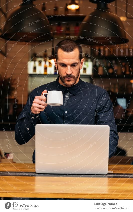 Businessman using his laptop in the Coffee Shop coffee friendly portrait young people lifestyle business businessman communication smartphone cellphone mobile